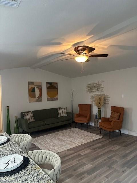 living room featuring lofted ceiling, hardwood / wood-style floors, and ceiling fan