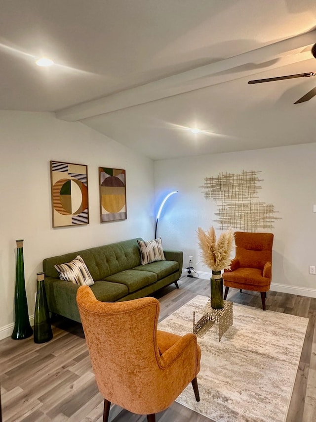 living room with ceiling fan, wood-type flooring, and vaulted ceiling with beams