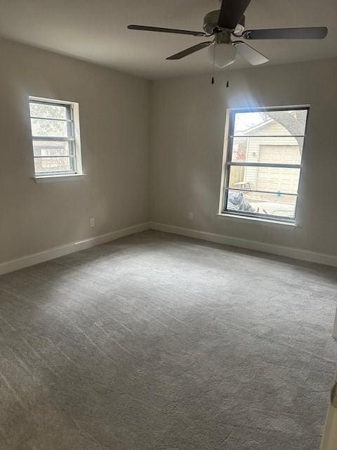 carpeted spare room with ceiling fan and a healthy amount of sunlight