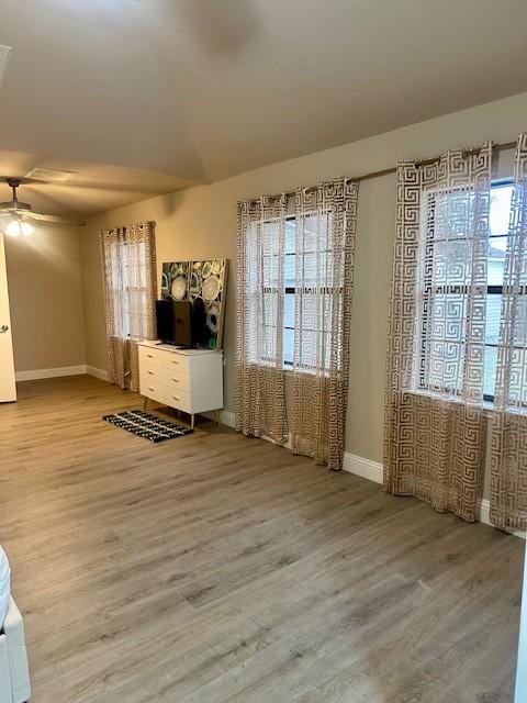 interior space featuring hardwood / wood-style flooring, a wealth of natural light, and ceiling fan