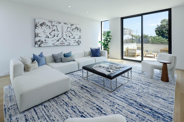 living room featuring floor to ceiling windows and hardwood / wood-style flooring