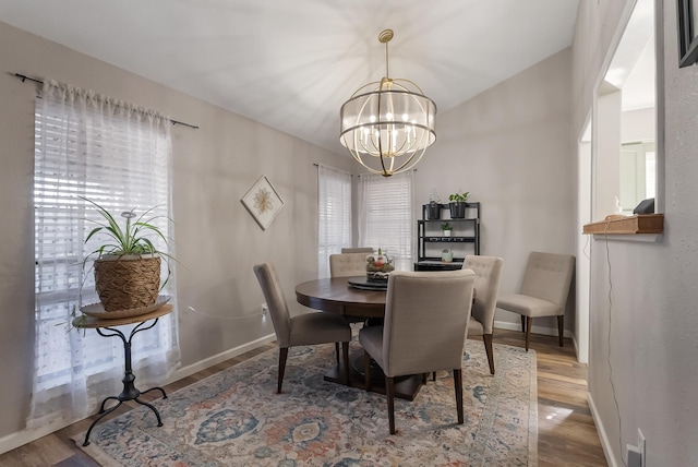 dining space featuring an inviting chandelier and hardwood / wood-style floors