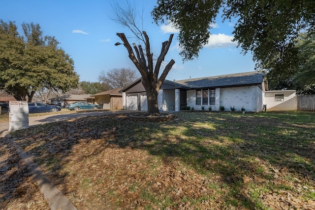 ranch-style house with a garage and a front yard