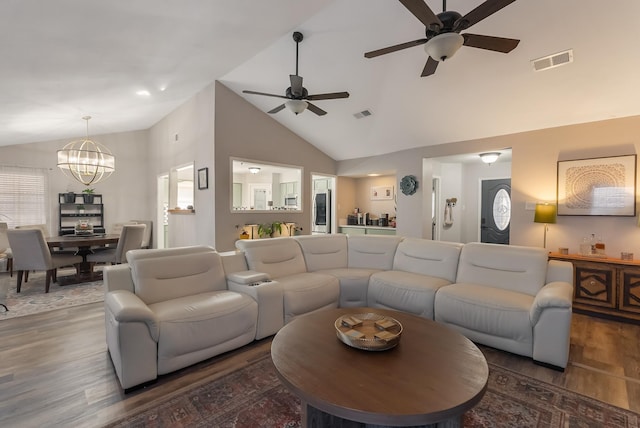 living room featuring high vaulted ceiling, dark hardwood / wood-style flooring, and a notable chandelier