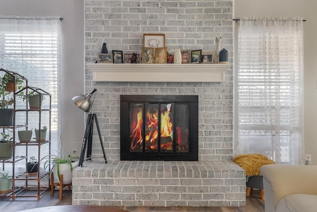 interior details with a brick fireplace and hardwood / wood-style flooring