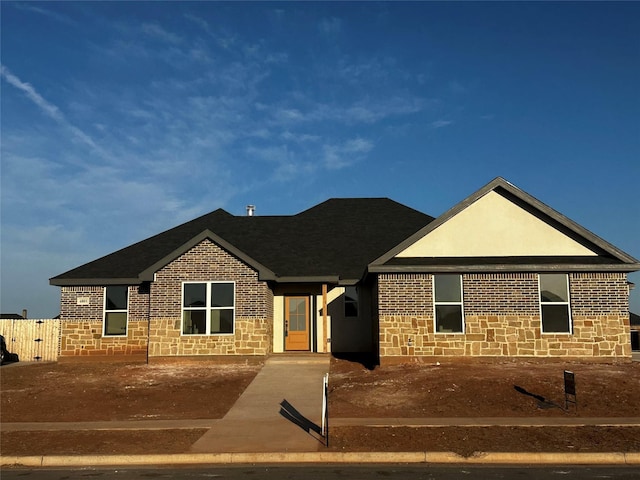 ranch-style house with stone siding and brick siding