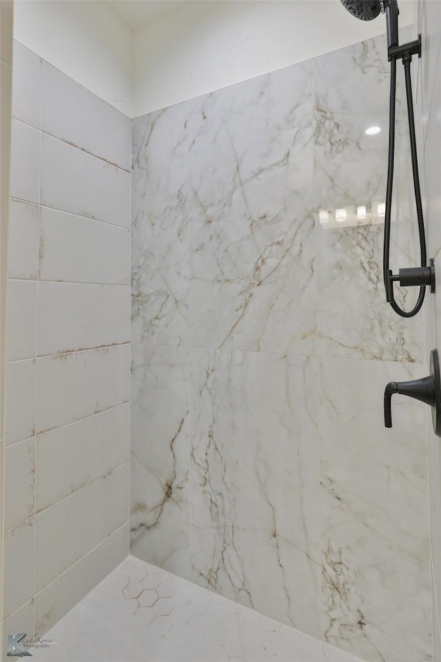 full bathroom featuring a marble finish shower