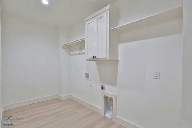 washroom with hookup for a washing machine, cabinet space, light wood-style flooring, hookup for an electric dryer, and baseboards