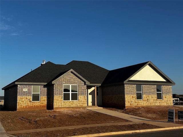 ranch-style house with stone siding