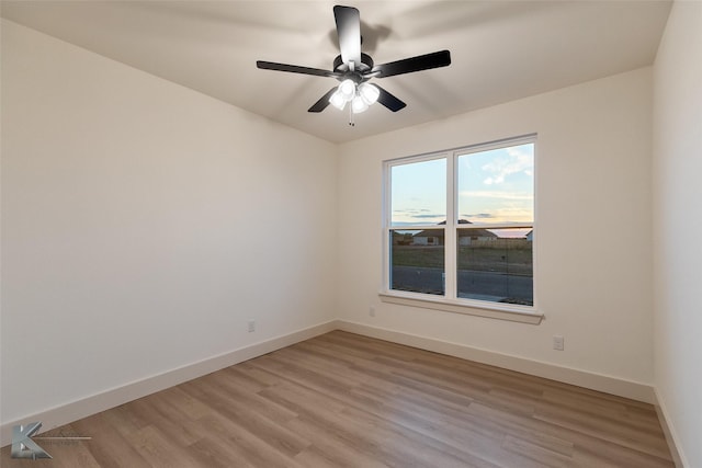 empty room with light hardwood / wood-style floors and ceiling fan