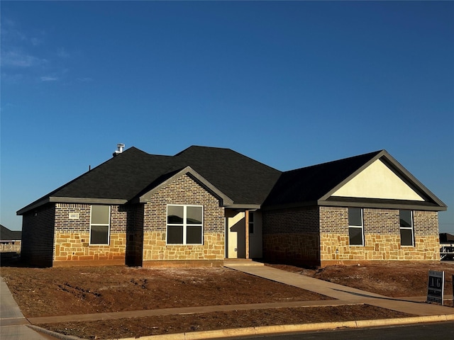 view of front of house with stone siding and brick siding