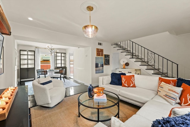 living room with ornamental molding and built in shelves