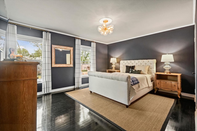 bedroom featuring dark hardwood / wood-style flooring, ornamental molding, a chandelier, and multiple windows