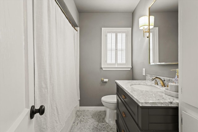 bathroom featuring toilet, tile patterned floors, and vanity