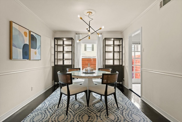 dining room with an inviting chandelier, plenty of natural light, dark hardwood / wood-style flooring, and crown molding