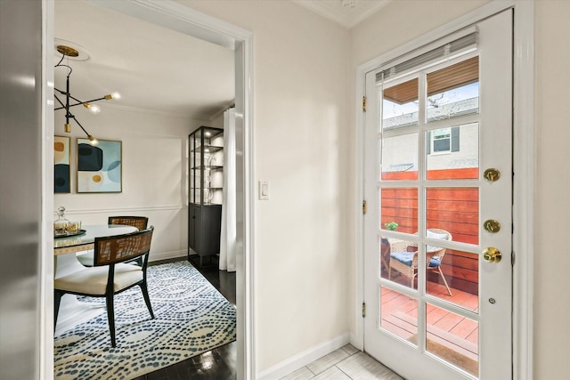 doorway to outside featuring light tile patterned floors and crown molding