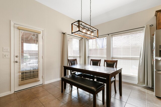 dining room featuring a wealth of natural light and dark tile patterned floors