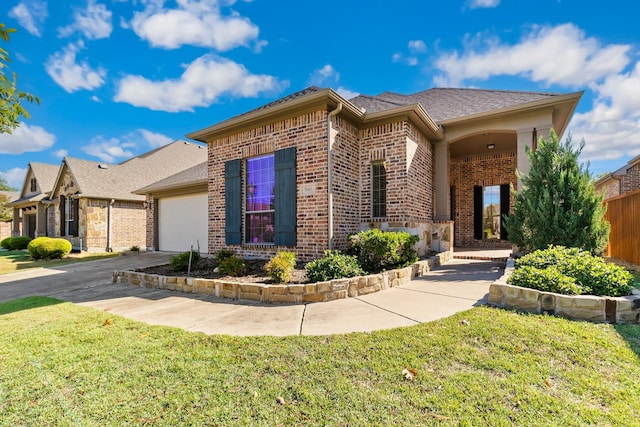 view of front of home with a garage and a front lawn