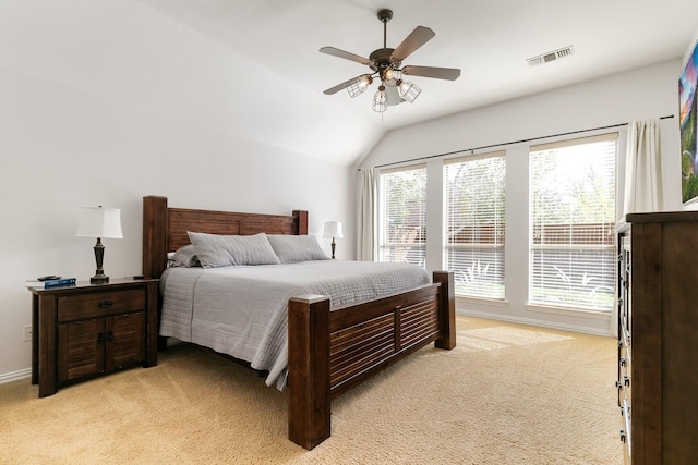 bedroom with vaulted ceiling, ceiling fan, and light carpet