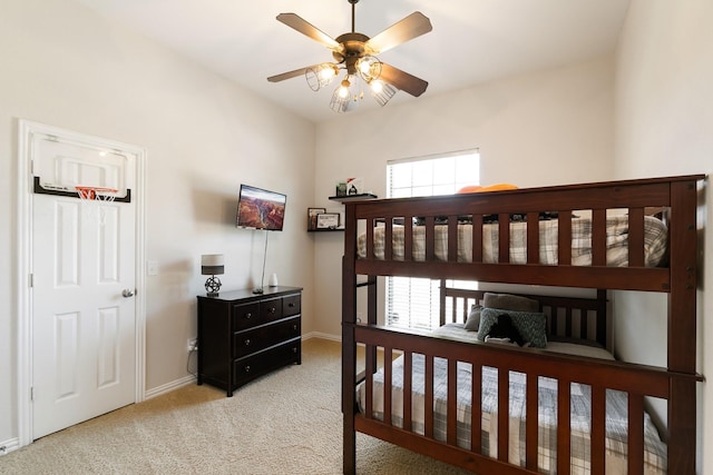 carpeted bedroom with ceiling fan and multiple windows