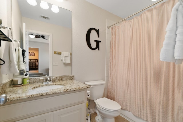 full bathroom with toilet, ceiling fan, shower / bath combination with curtain, and vanity