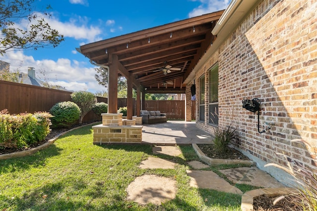 view of patio / terrace with ceiling fan and an outdoor living space