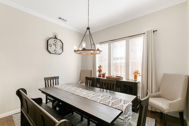 dining space with dark hardwood / wood-style floors and a notable chandelier