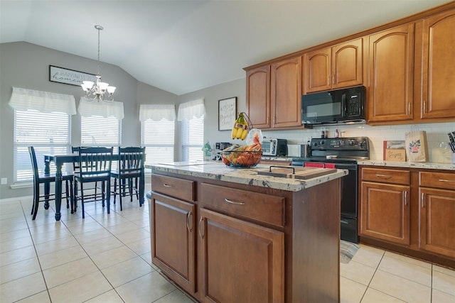 kitchen featuring vaulted ceiling, light tile patterned floors, a kitchen island, pendant lighting, and black appliances