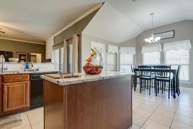 kitchen with lofted ceiling, a kitchen island, hanging light fixtures, and light tile patterned floors