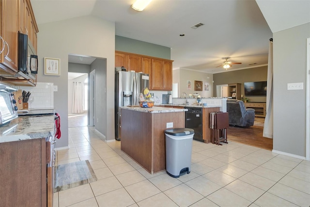 kitchen with backsplash, a center island, black appliances, light tile patterned flooring, and kitchen peninsula