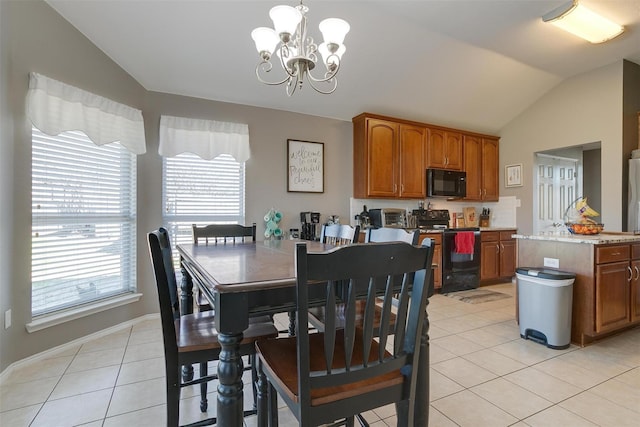 tiled dining area featuring an inviting chandelier and vaulted ceiling