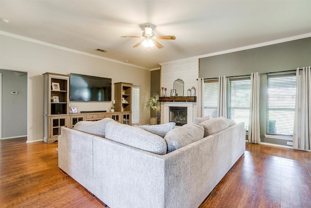 1721 Vista Ridge Dr W, Midlothian, TX 76065 - living room featuring a ceiling fan, crown molding, wood finished floors, a fireplace, and baseboards