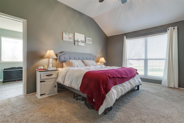 carpeted bedroom with vaulted ceiling and ceiling fan