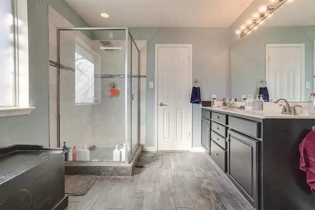 bathroom featuring vanity and a shower with shower door