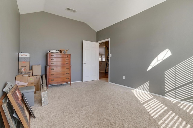 bedroom featuring lofted ceiling and light colored carpet