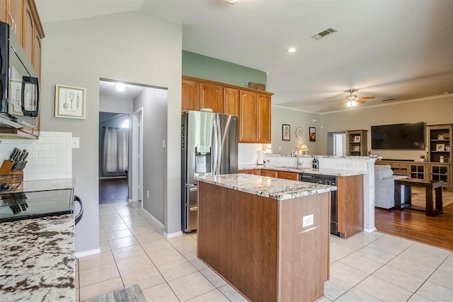 1721 Vista Ridge Dr W, Midlothian, TX 76065 - kitchen with black appliances, a peninsula, light tile patterned floors, a center island, and light stone countertops