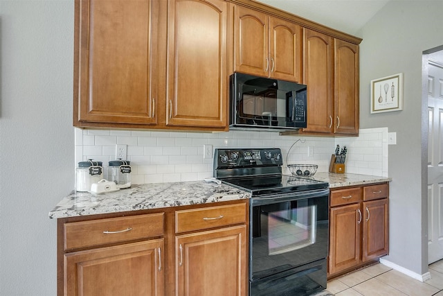 1721 Vista Ridge Dr W, Midlothian, TX 76065 - kitchen featuring black appliances, decorative backsplash, light tile patterned flooring, light stone counters, and brown cabinets