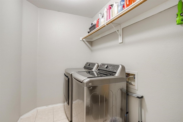 1721 Vista Ridge Dr W, Midlothian, TX 76065 - laundry area with washer and clothes dryer, light tile patterned flooring, and baseboards