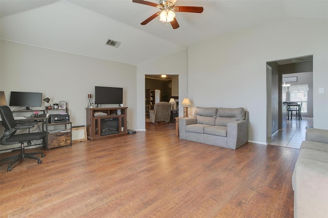 living room featuring lofted ceiling, hardwood / wood-style floors, and ceiling fan