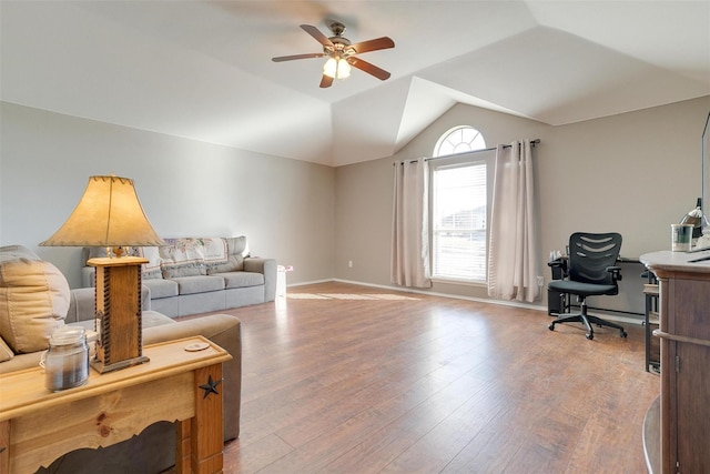 living room featuring wood-type flooring, vaulted ceiling, and ceiling fan