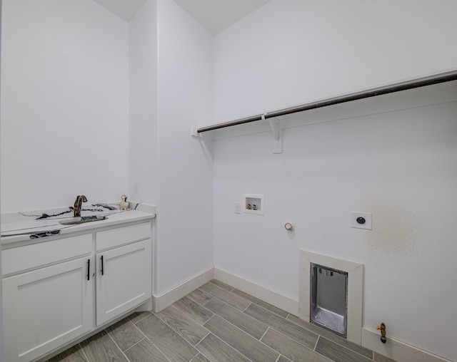 laundry area featuring cabinets, gas dryer hookup, electric dryer hookup, and washer hookup