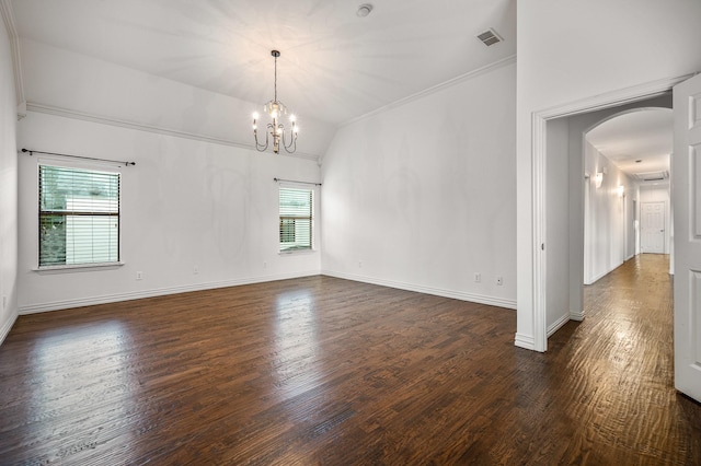 spare room featuring dark hardwood / wood-style flooring, lofted ceiling, and a healthy amount of sunlight