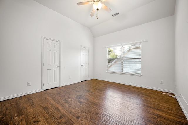 interior space featuring ceiling fan, vaulted ceiling, dark hardwood / wood-style flooring, and two closets