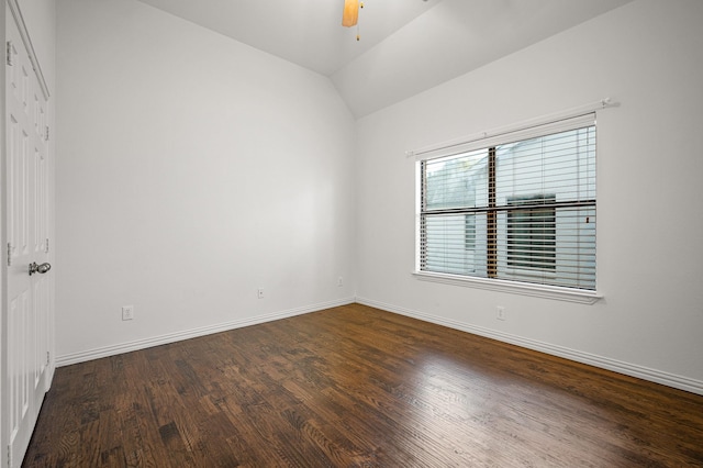 spare room with lofted ceiling, wood finished floors, a ceiling fan, and baseboards