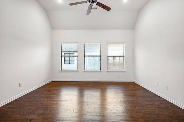 empty room with lofted ceiling, ceiling fan, and dark hardwood / wood-style flooring