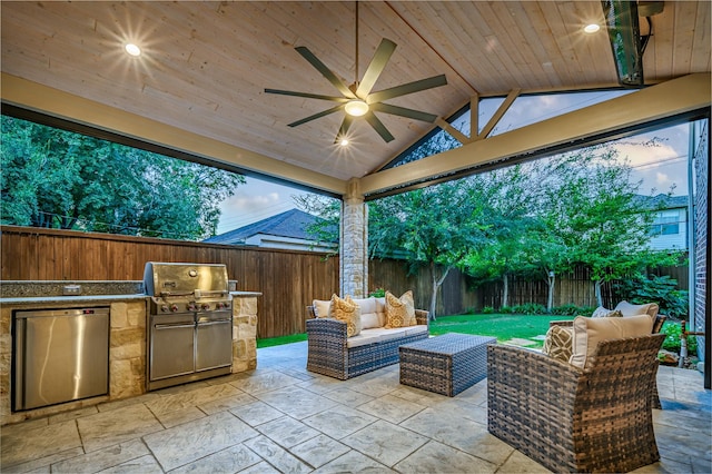 view of patio / terrace featuring exterior kitchen, outdoor lounge area, grilling area, and ceiling fan