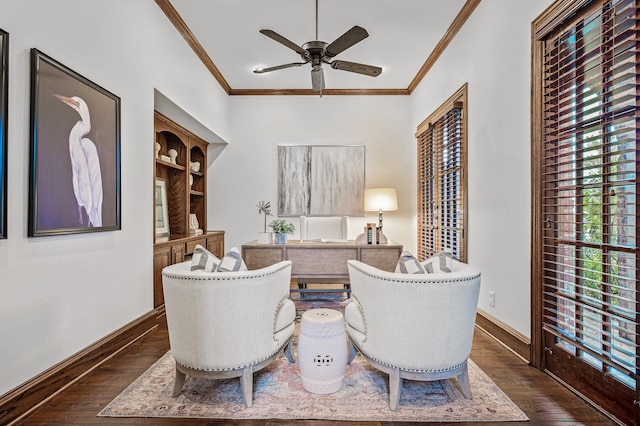 sitting room with ceiling fan, ornamental molding, dark hardwood / wood-style floors, and built in shelves