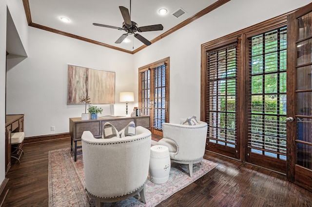 living area featuring ceiling fan, dark wood-type flooring, and ornamental molding