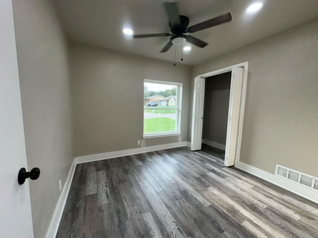 unfurnished room with ceiling fan and dark hardwood / wood-style floors