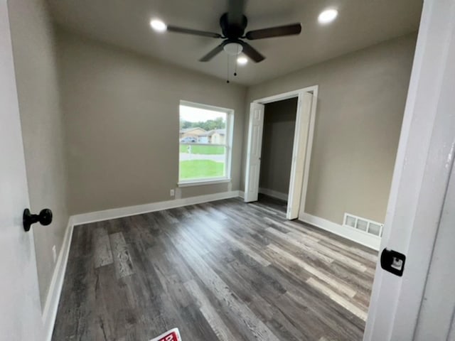 unfurnished bedroom featuring ceiling fan, hardwood / wood-style floors, and a closet